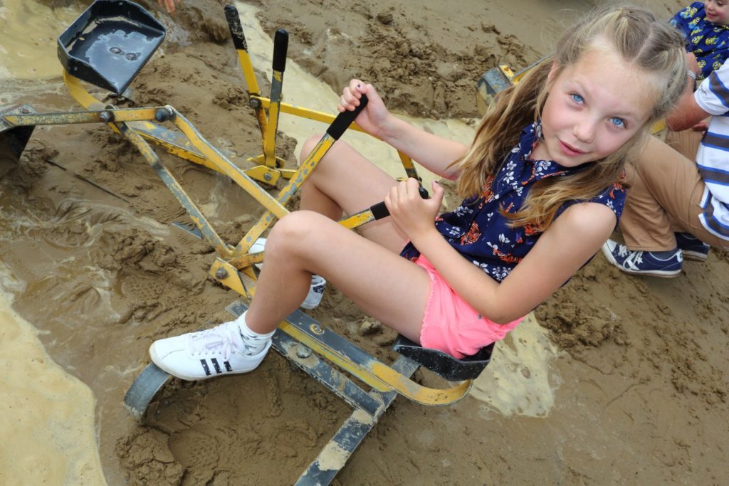 Girl on sandpit digger