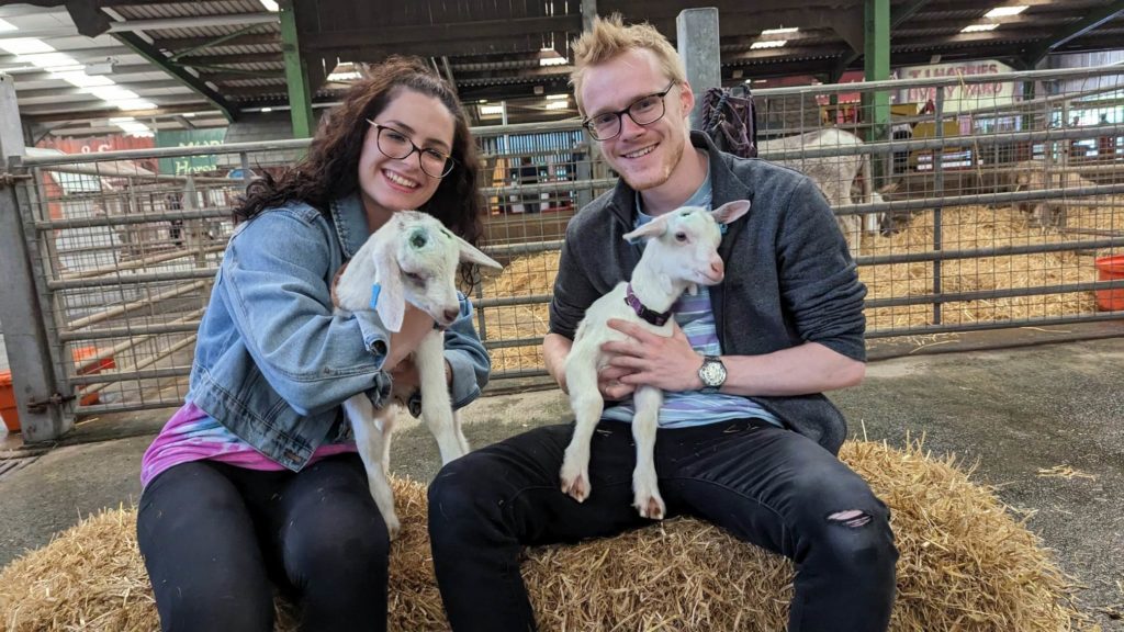 Image of adults with goat kids